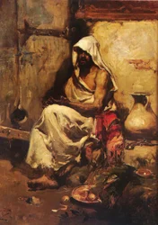 Un arabo che esamina una pistola